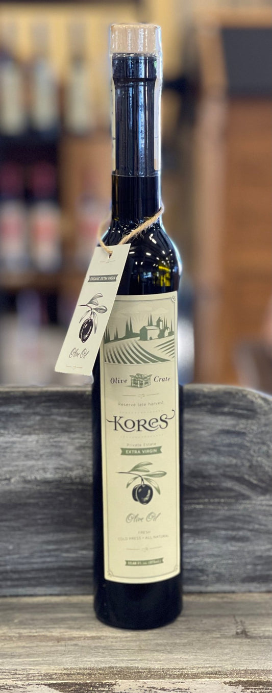 Kores Estate Manaki EVOO 350ml bottle on olive wood surface, Greece