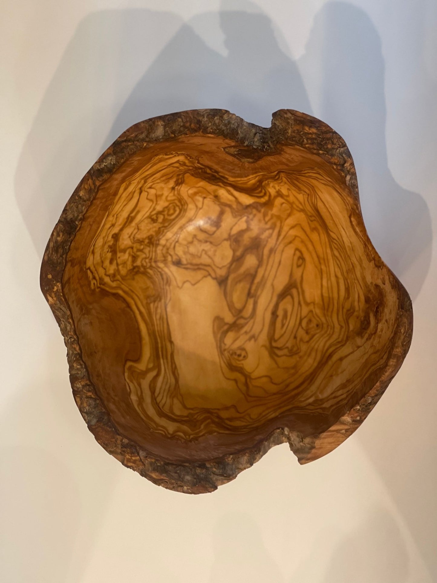 Olive wood salad bowl natural edge, top view, white background