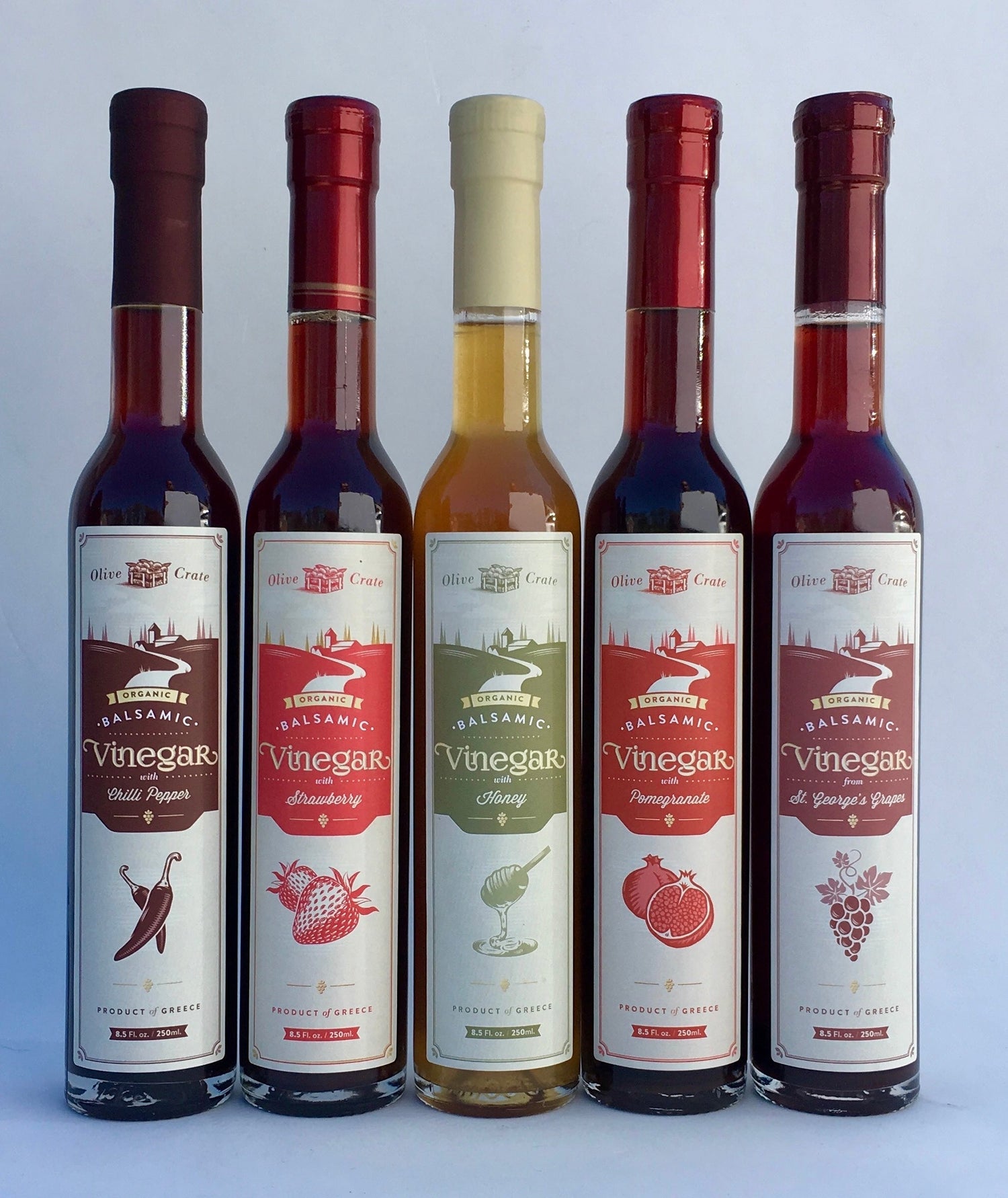 organic vinegar bottles in a row on a white background
