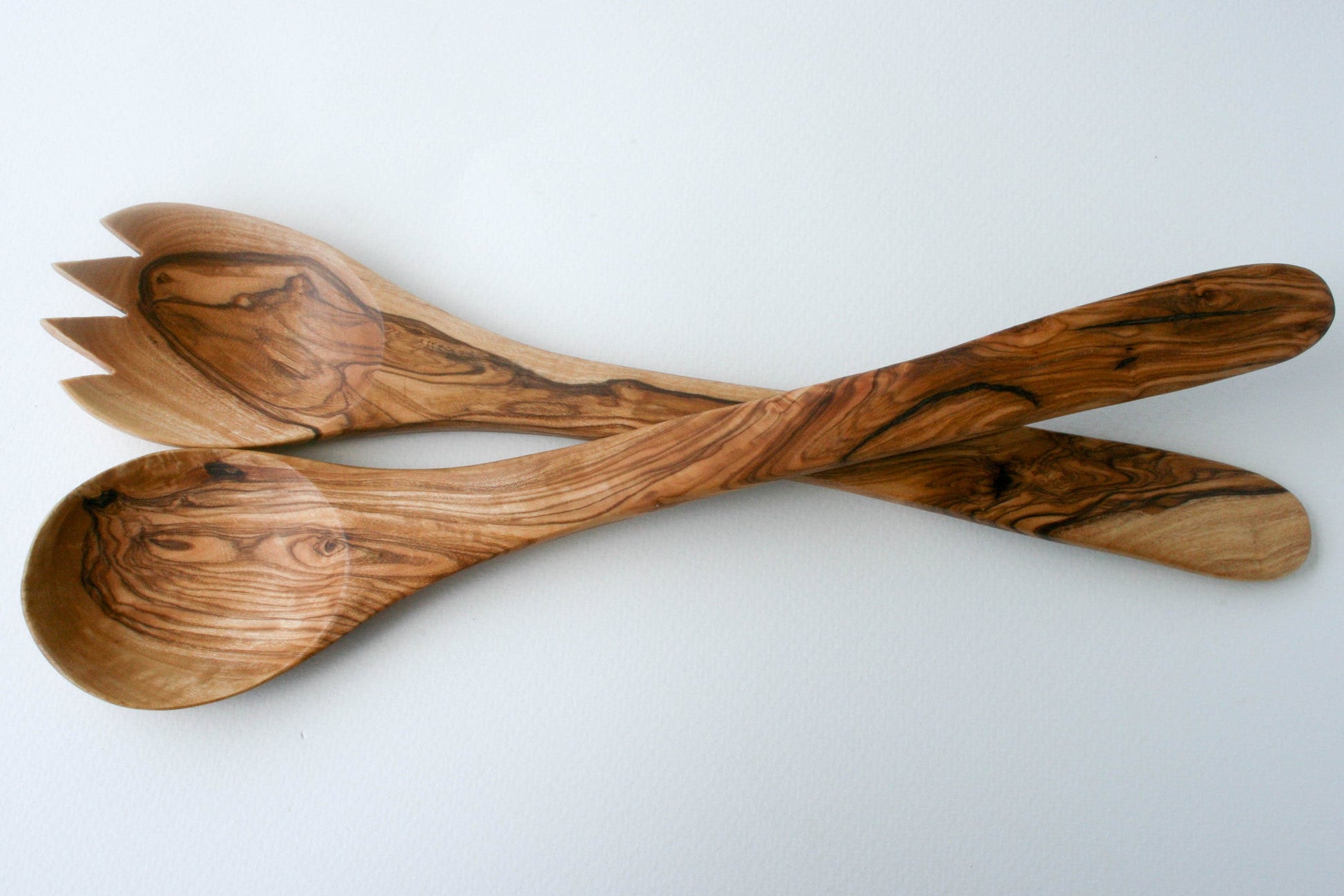 Hand-carved olive wood salad servers spoon and spork set, white background