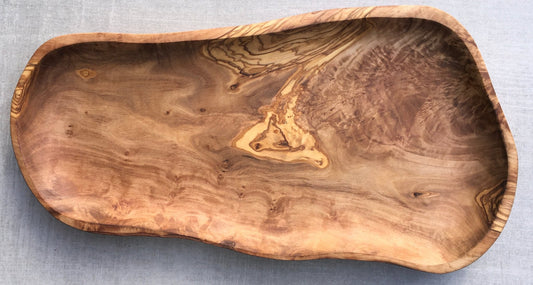 Hand-carved olive wood serving platter with slightly irregular rectangular form and natural live edge grain